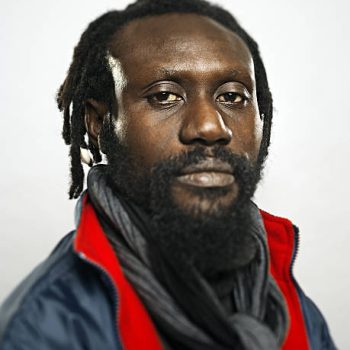 Afro american man looking at camera with jacket and winter wear.